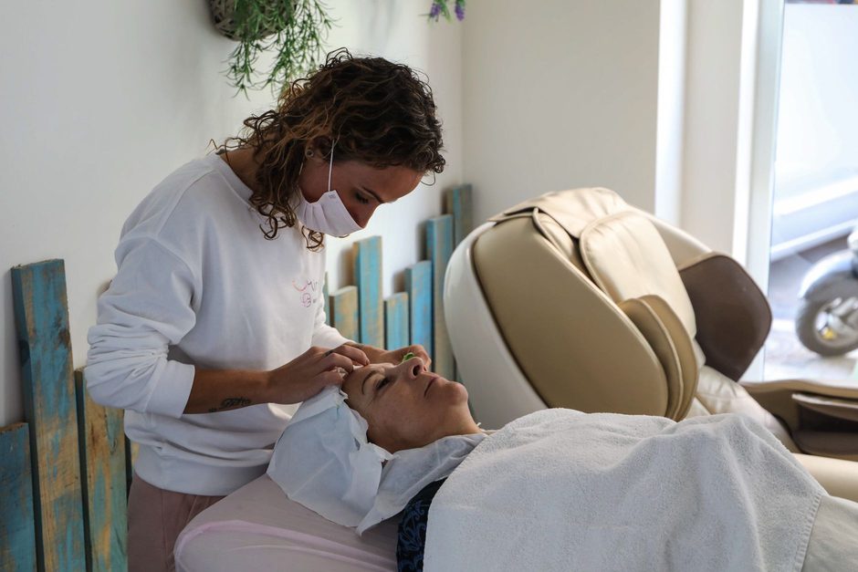 Beauty therapist giving a client a facial