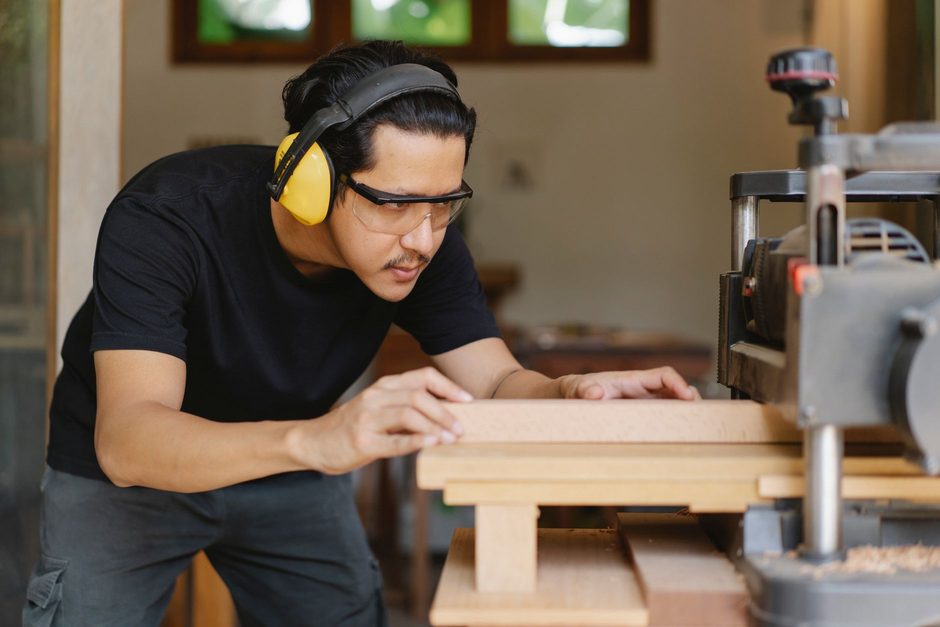 Carpenter working on timber at a bench