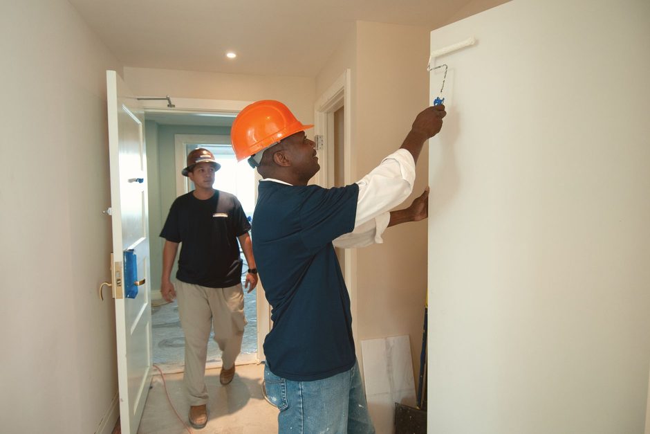 Decorators painting a room