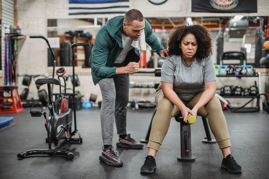 Personal trainer coaching a client in a gym