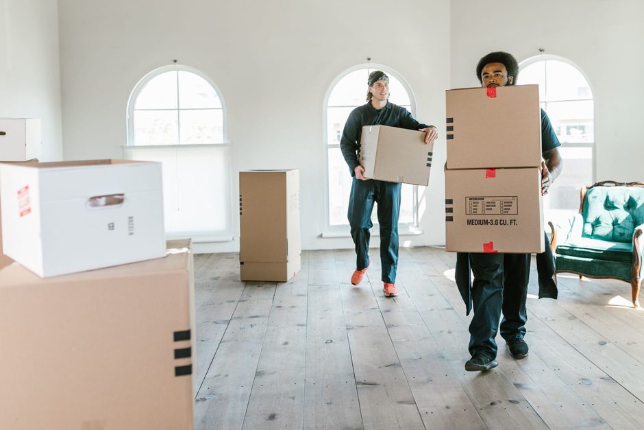 Removal team carrying boxes into a van