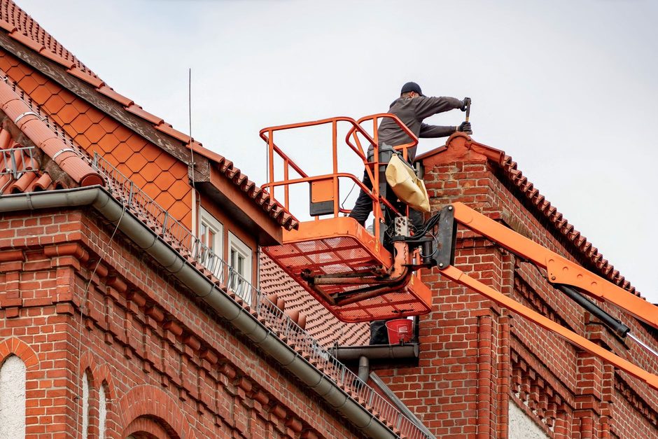 Roofer at work on a house roof